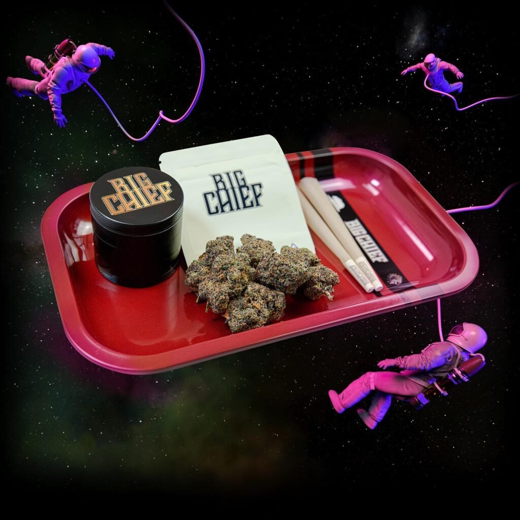 Big Chief flower, grinder and pre-rolls on a red rolling tray, illustrating how Big Chief products are made
